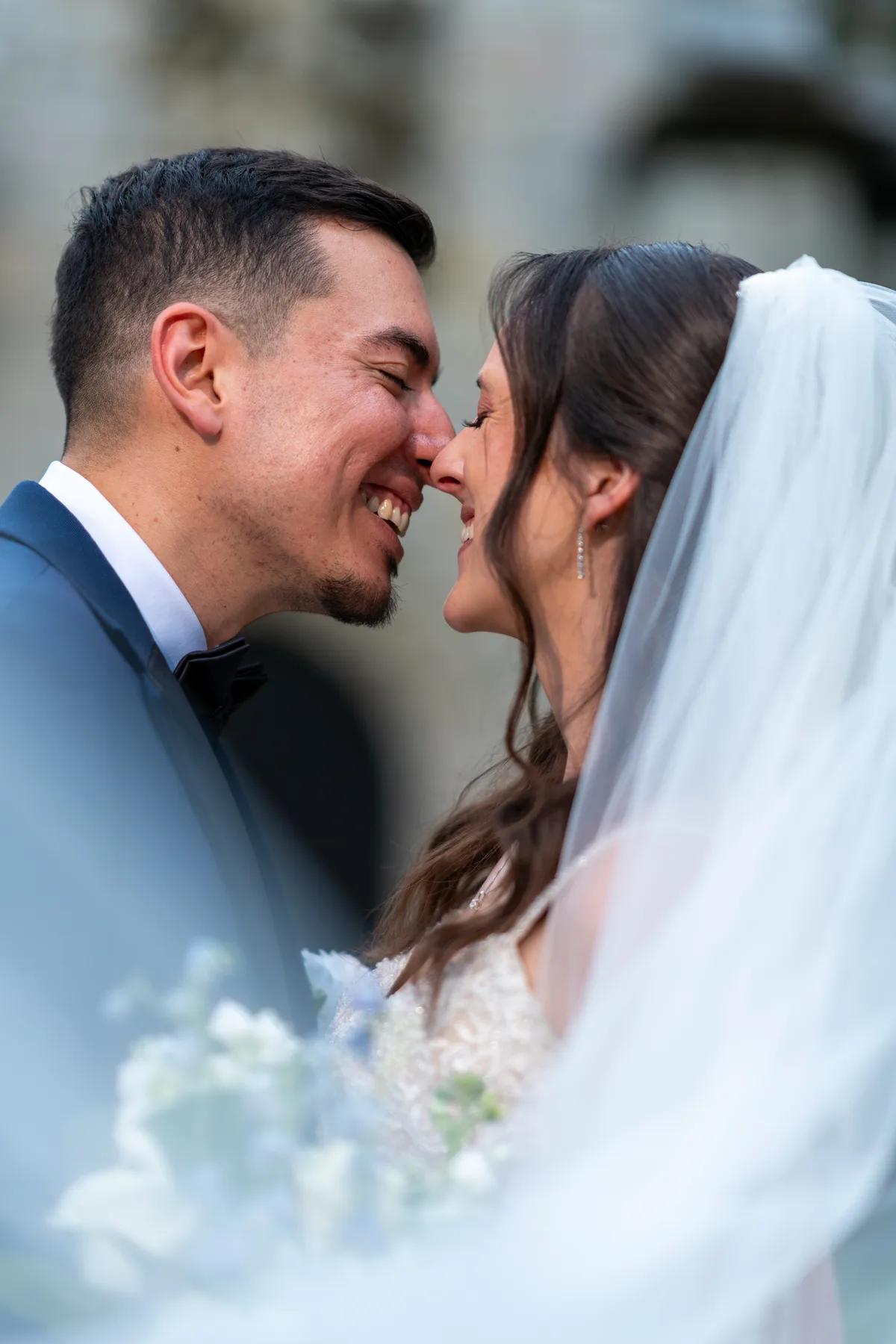 a close-up of a bride and groom sharing an intimate moment during their wedding day.